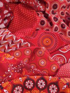 Shweshwe fabric from South Africa, known for its distinctive small geometric patterns and indigo, brown, or red hues, traditionally worn during ceremonies and symbolizing South African heritage. Source: https://za.pinterest.com/pin/720857484110824811/