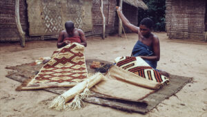 Kuba cloth from the Democratic Republic of Congo, made from raffia palm fibers and featuring intricate geometric patterns. The fabric is known for its cultural and spiritual significance, often used in ceremonial garments. Source: https://www.npr.org/sections/goatsandsoda/2018/10/20/658101128/a-great-african-kingdom-tells-its-history-in-fabulous-royal-clothes